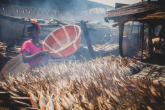 12 July 2014,  woman smoking the fish